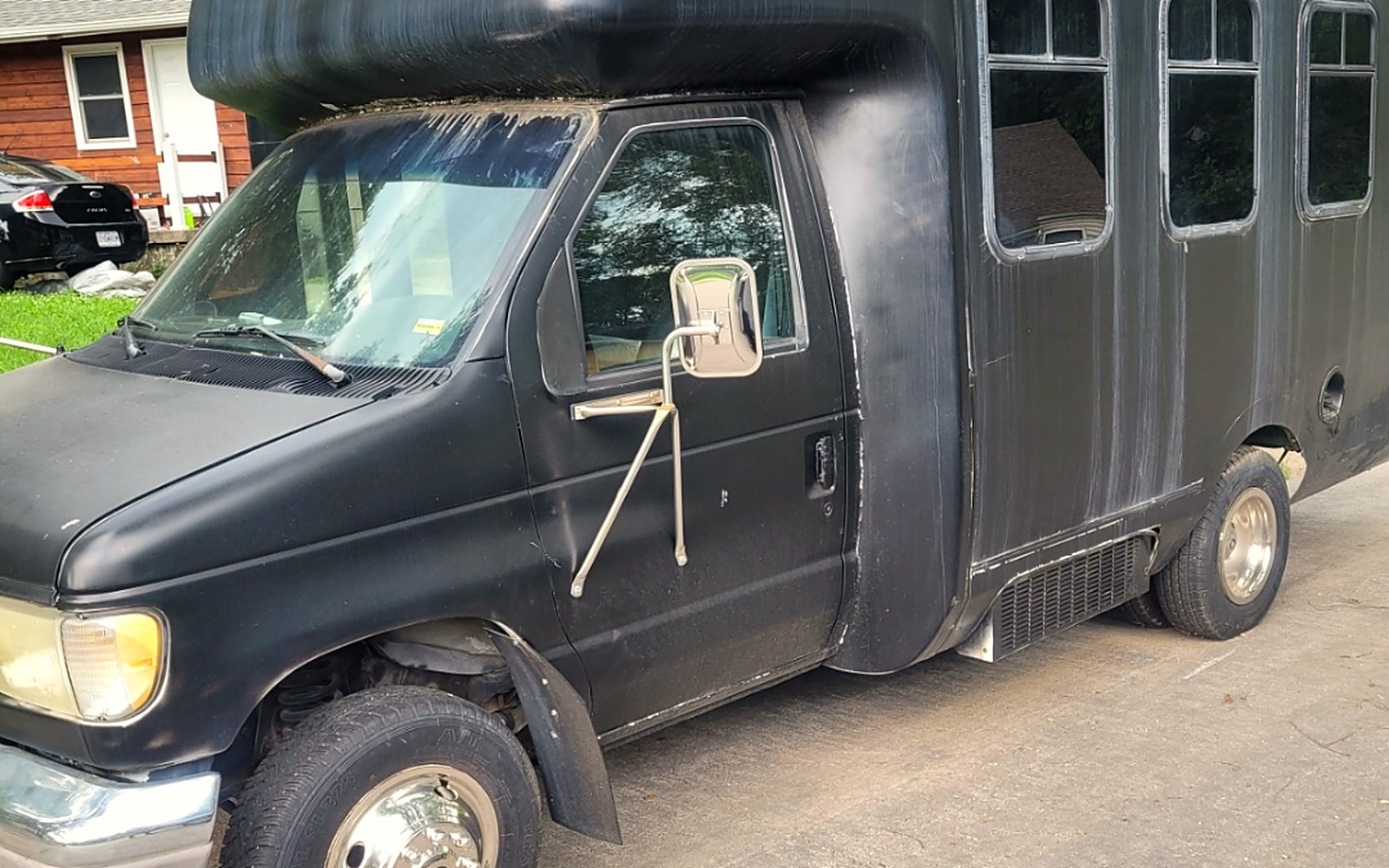 OSG shuttle bus &mdash; a Ford E-Series cutaway painted matte black, the vehicle assigned to Kansas City veteran transportation runs.